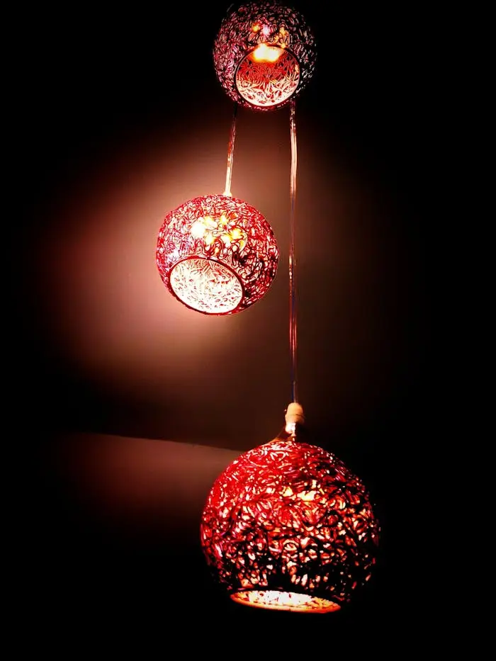 Three red lanterns casting a warm, ambient glow, perfect for festive indoor decoration.